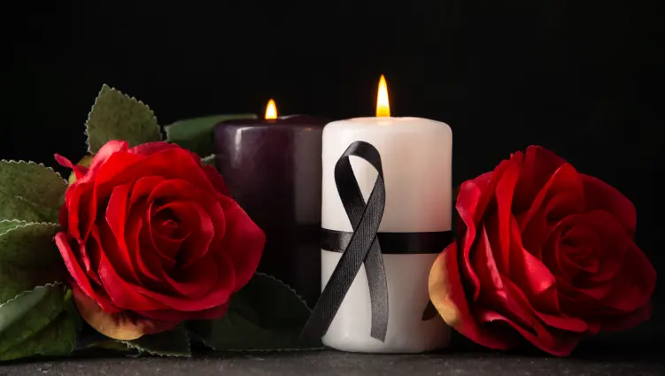Memorial candles and red roses honoring Cathy Ann